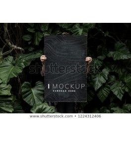 Female in a tropical background holding a signboard mockup
