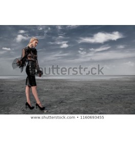 Full length portrait of a beautiful gothic woman in black elegant clothes posing outdoor. Beauty, fashion.